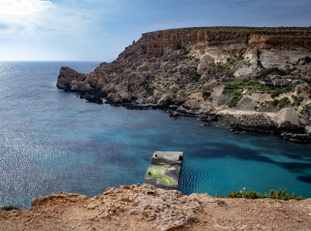 This image shows the cliffs and rocky terrain of the Majjistral Heritage Park on a sunny day.