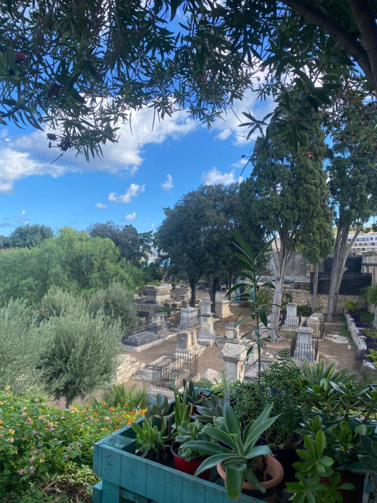 A view of the Msida Garden of Rest, with tombstones and landscaped gardens.